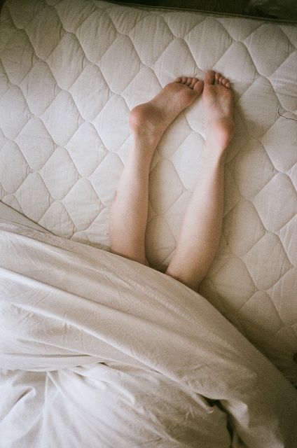 feet-between-sheets