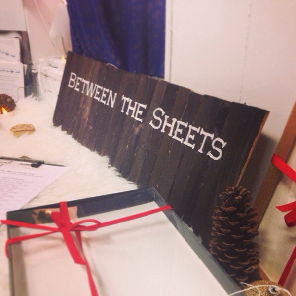 DIY wood painted sign for Between the Sheets lingerie booth