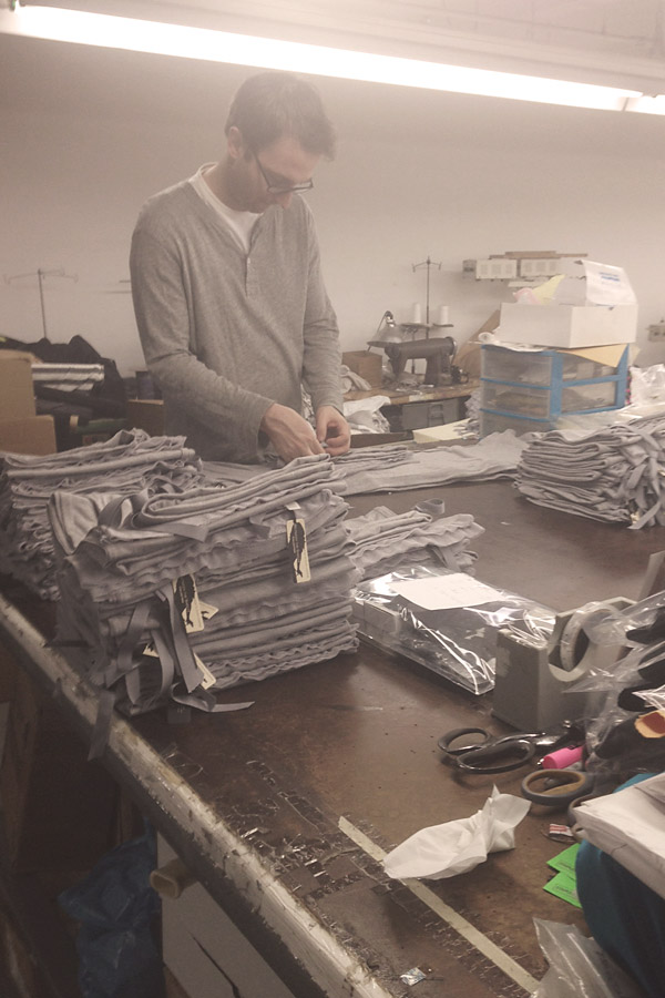 Between the Sheets - Made in NYC behind the scenes at New york city factory, cofounder Josh packing and inspecting