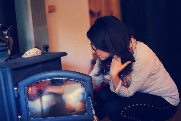 BTS photoshoot in Woodstock NY - behind the scenes Layla lighting the woodstove in our cabin