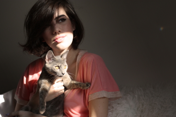 woman holding torie in coral tee