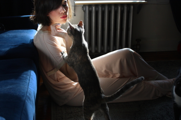 girl kissing tortie in pajamas